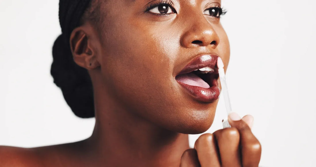Brown skin Model applying Lip Gloss