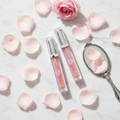 Baby Lips Lip Gloss Plumper lifestyle flat lay on white marble with pink roses